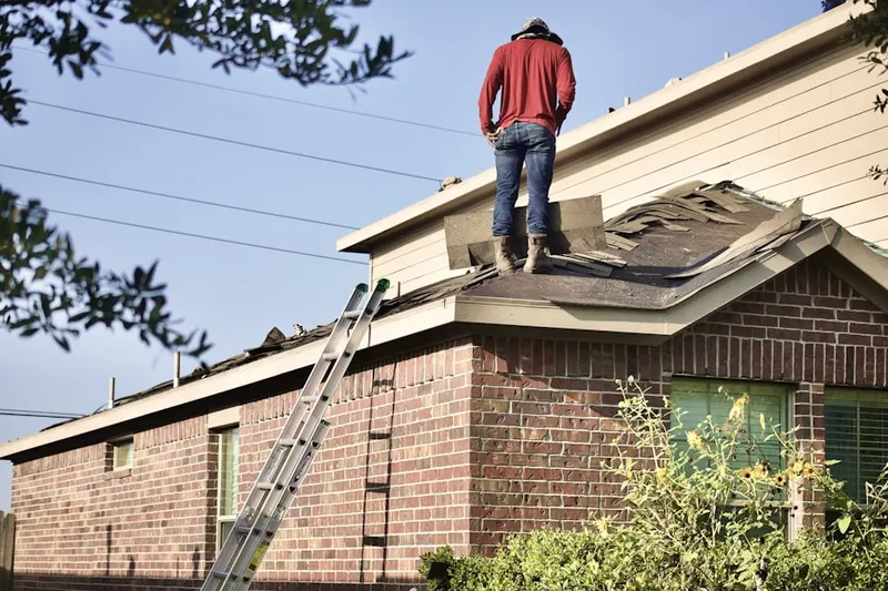 Professional roofer working on a residential roof in Darien Ridge